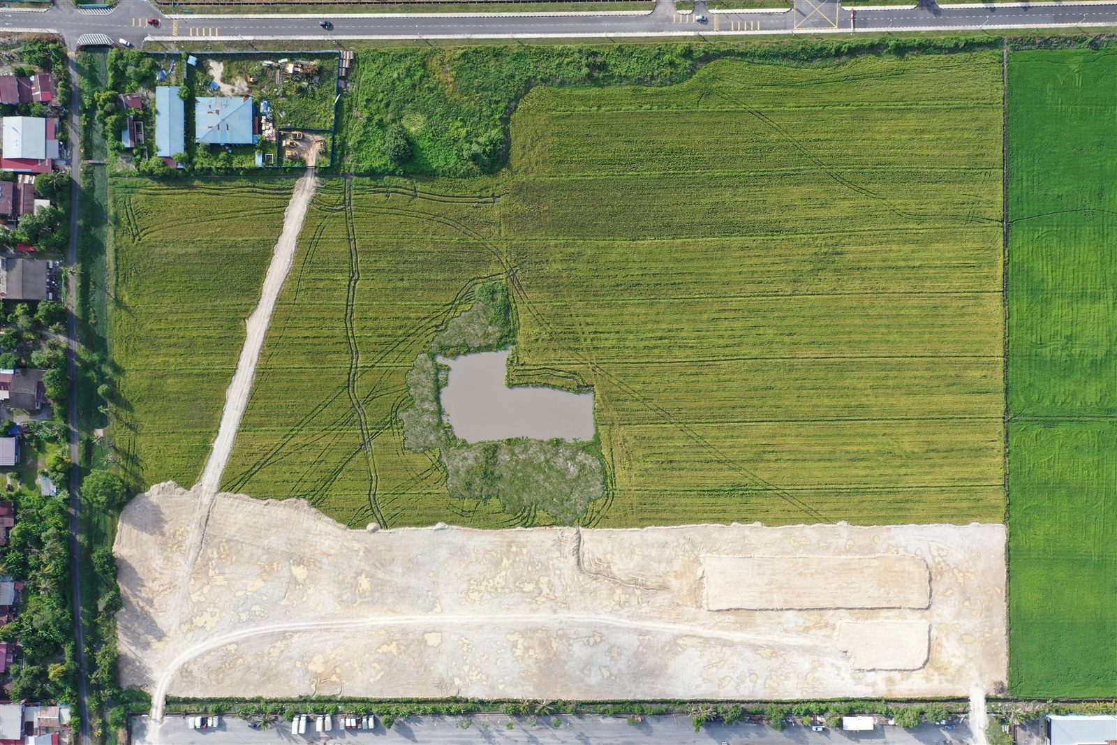 Aerial view of the surrounding paddy fields and access road